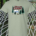 Happy Camper scene in woods with logs – Sage T-shirt
